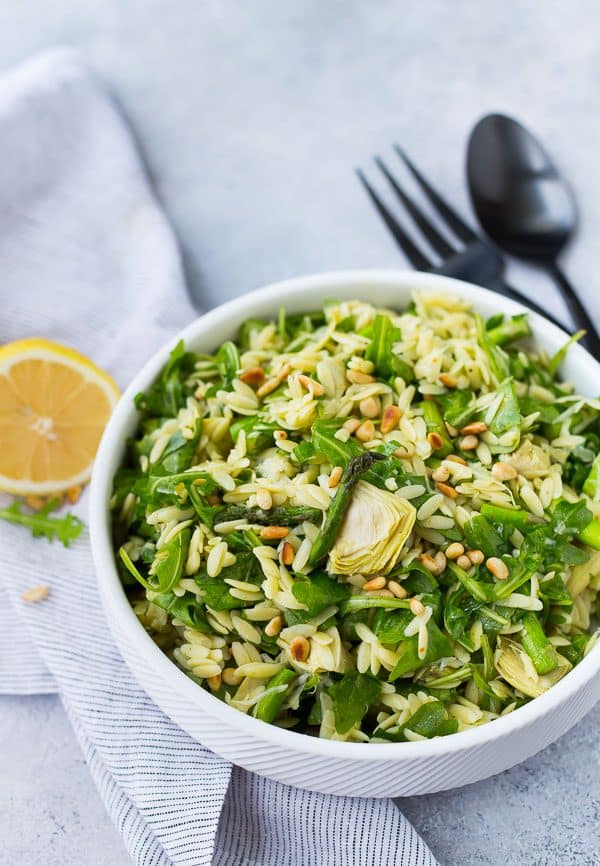 image of spring orzo salad in a bowl with lemon