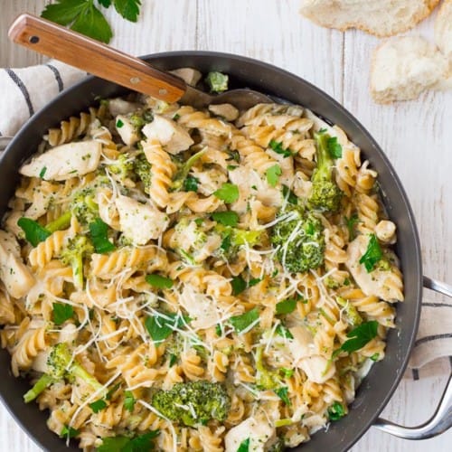 image of one pan chicken alfredo recipe with broccoli, wooden spoon