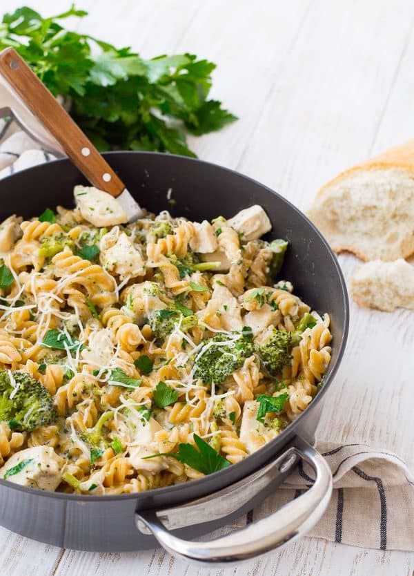 Partial image of chicken Alfredo in large pot with spoon inserted.