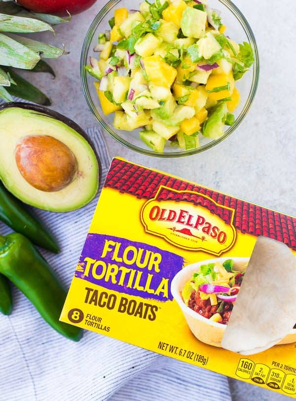 These Shrimp Tacos are a refreshing taste of the tropics thanks the zesty avocado, mango and pineapple salsa. They're easy to make and are a hit for any party or taco night. The extra salsa is amazing on chips or sprinkled on a salad! Get the quick and easy taco recipe on RachelCooks.com!