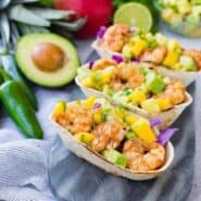 These Shrimp Tacos are a refreshing taste of the tropics thanks the zesty avocado, mango and pineapple salsa. They're easy to make and are a hit for any party or taco night. The extra salsa is amazing on chips or sprinkled on a salad!