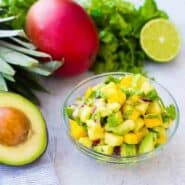 Mango Avocado Salsa is the perfect topping to any taco or salad, and it's irresistible piled up on a chip! You'll love the creamy avocado, sweet mango, and tart pineapple in every bite! Get the easy salsa recipe on RachelCooks.com!