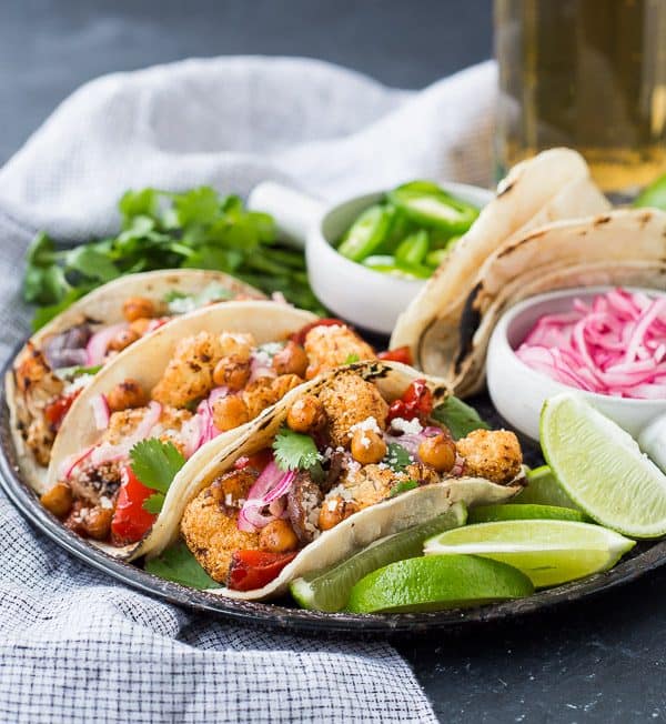 These easy vegetarian cauliflower tacos are full of flavor and protein! Even meat-lovers are going to flip over these fun tacos. Whether it's for Meatless Monday or a full-on vegetarian lifestyle, you're going to love these! They're also easy to make vegan. Make them tonight! 