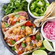 These easy vegetarian cauliflower tacos are full of flavor and protein! Even meat-lovers are going to flip over these fun tacos. Whether it's for Meatless Monday or a full-on vegetarian lifestyle, you're going to love these! They're also easy to make vegan. Make them tonight! 