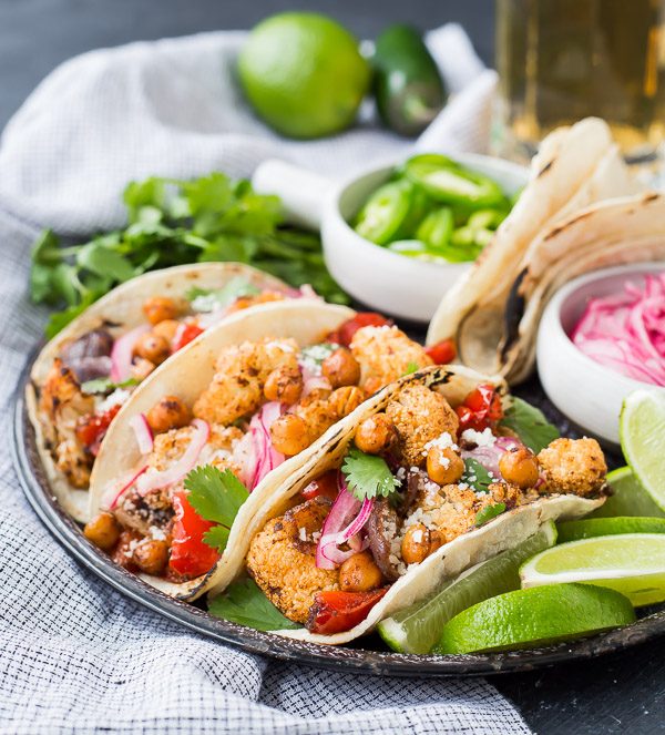 These easy vegetarian cauliflower tacos are full of flavor and protein! Even meat-lovers are going to flip over these fun tacos. Whether it's for Meatless Monday or a full-on vegetarian lifestyle, you're going to love these! They're also easy to make vegan. Make them tonight! 