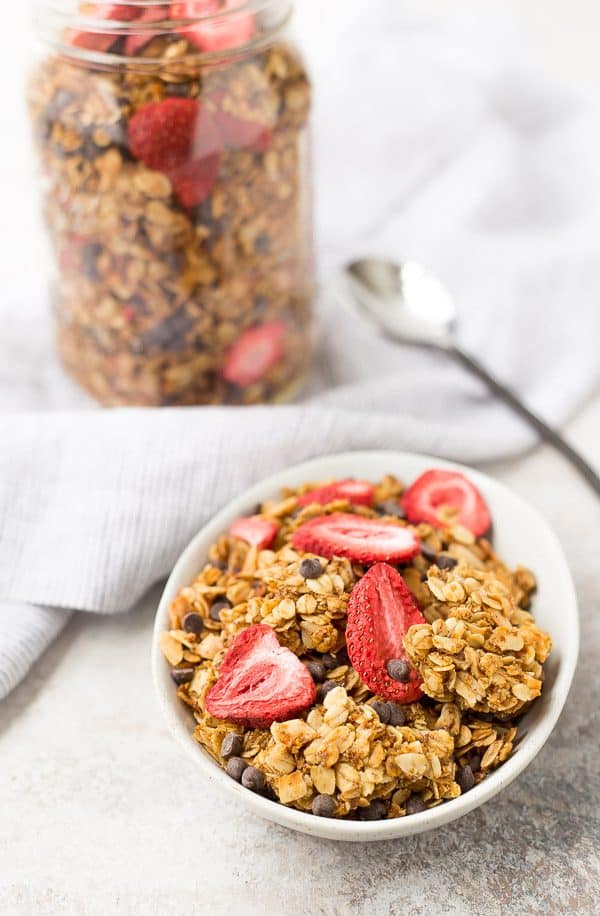 chocolate chip granola in bowl with jar in background