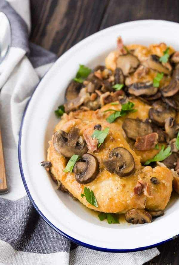 Partial overhead of chicken marsala in dish.