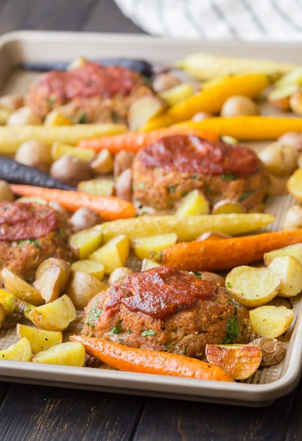 Meatloaves and veggies on sheet pan.