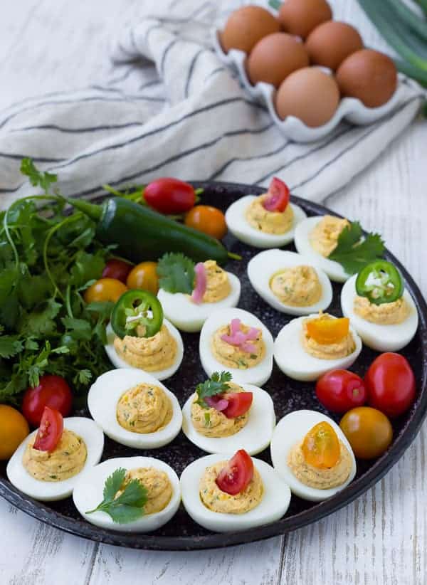 Image of Southwest Deviled Eggs on black platter with garnishes