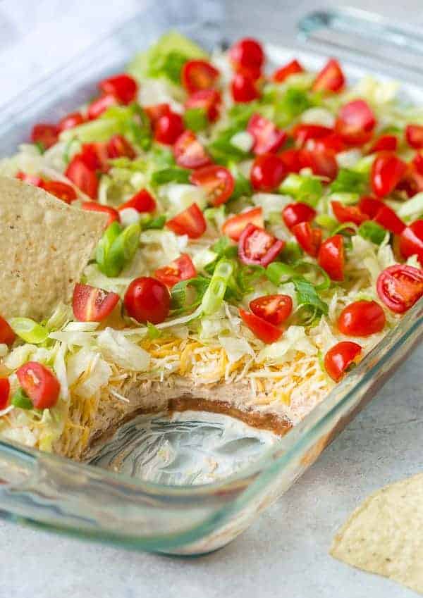 7 layer dip with scoop out to show the layers, chip dipped in the top.