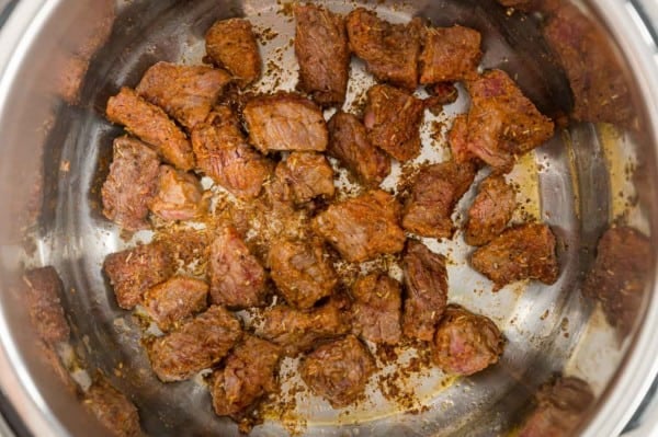 Browned beef chunks inside the Instant Pot.