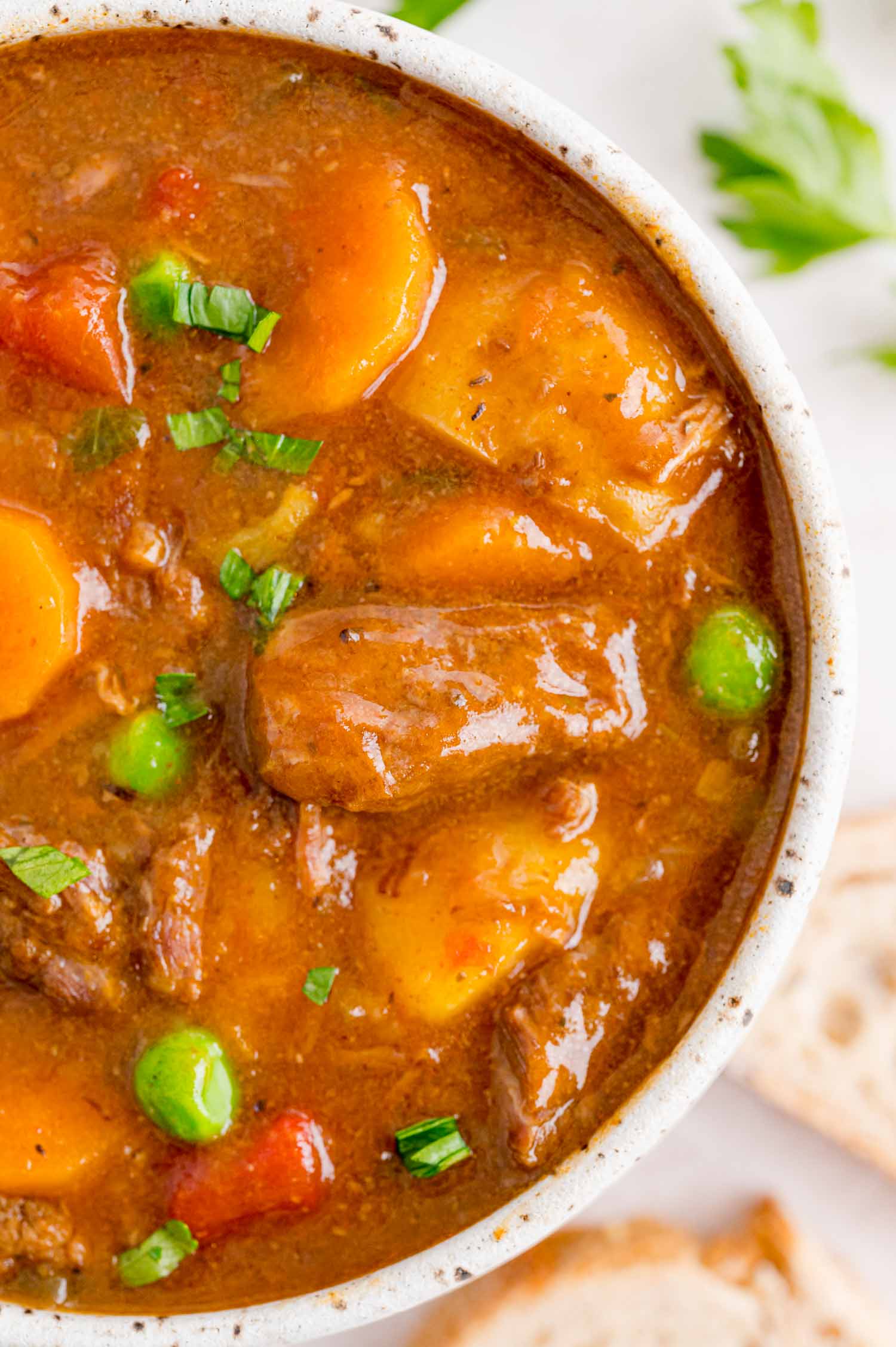 Close up overhead view of Instant Pot beef stew in a white bowl.