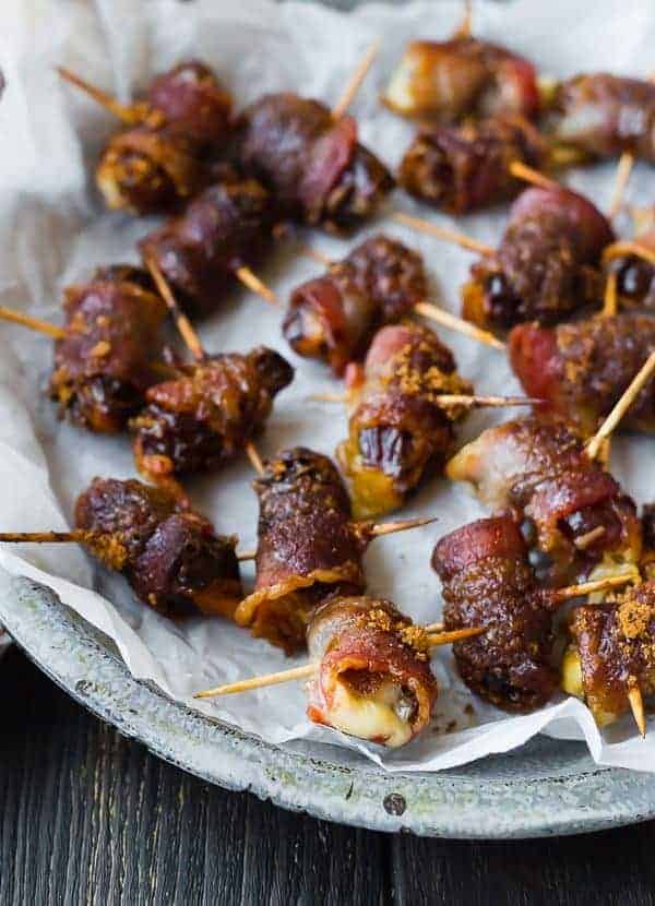 These bacon wrapped dates are stuffed with fontina cheese and sprinkled with an insanely delicious brown sugar spice rub. They're going to be the hit of your next party! 