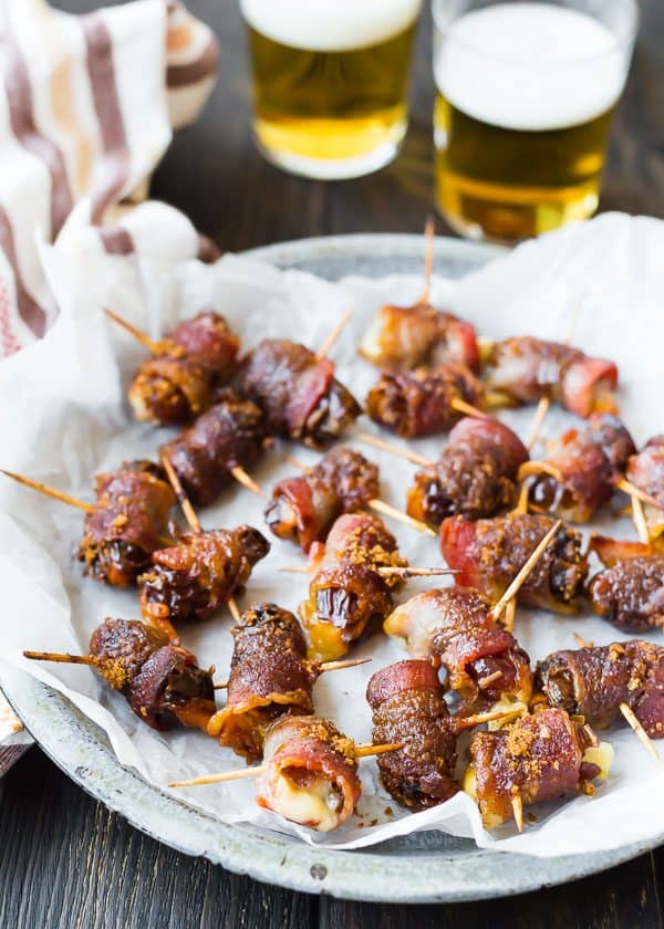 These bacon wrapped dates are stuffed with fontina cheese and sprinkled with an insanely delicious brown sugar spice rub. They're going to be the hit of your next party! 