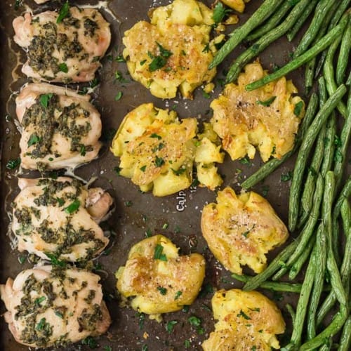 Image of sheet pan dinner with chicken thighs, potatoes, and green beans. Close up photo.