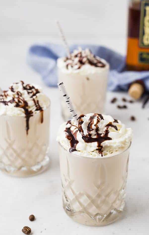 Image of three whiskey milkshakes topped with whipped cream and chocolate sauce.