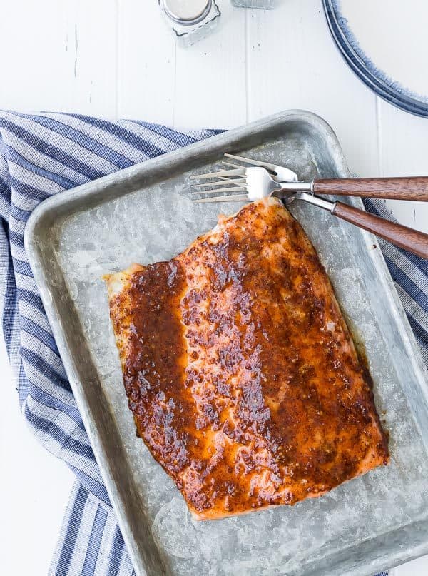 This easy five ingredient baked salmon is going to be your weeknight go-to salmon recipe. The glaze is the perfect balance of spicy and sweet. Try it tonight!