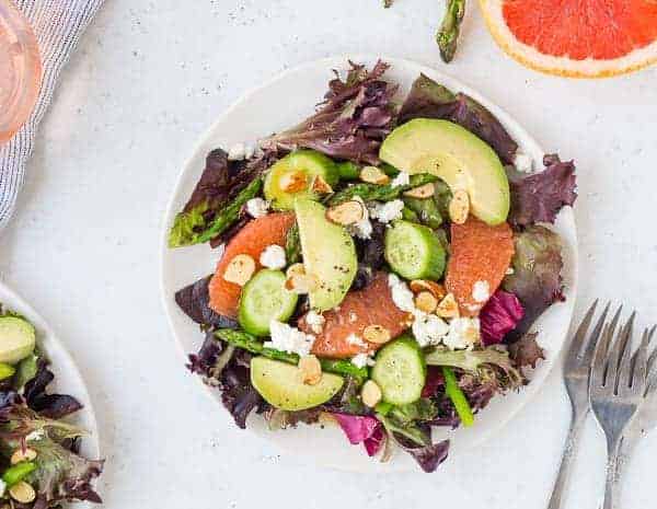 Overhead of spring salad with vinaigrette.