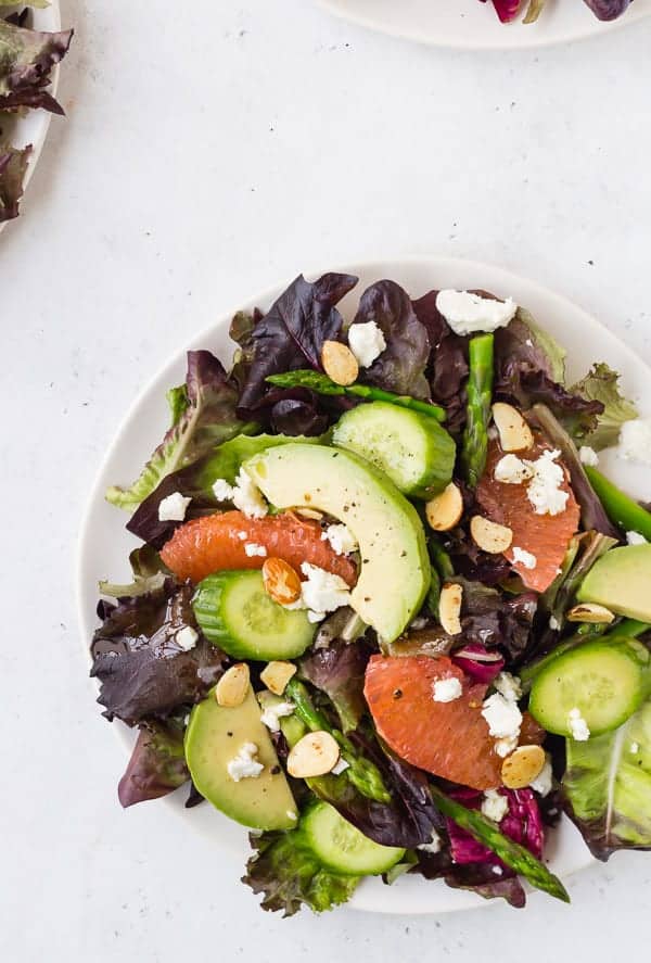 Overhead of composed salad on white plate.