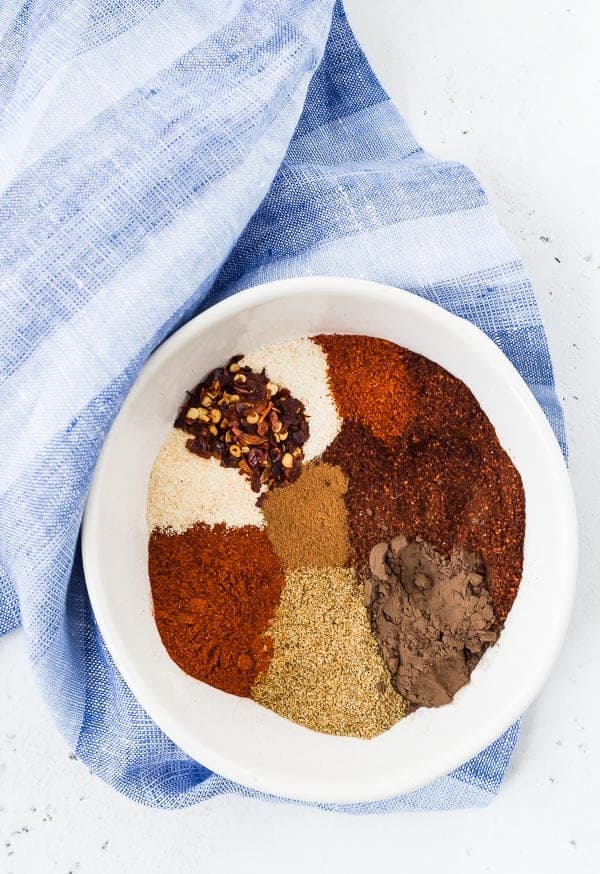 Overhead view of spices in a white bowl.