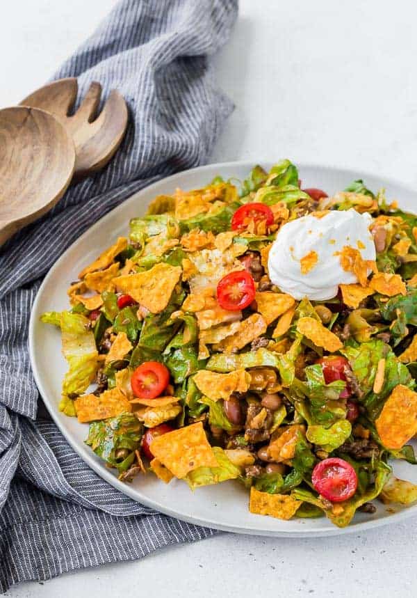 image of classic taco salad on a plate, garnished with sour cream