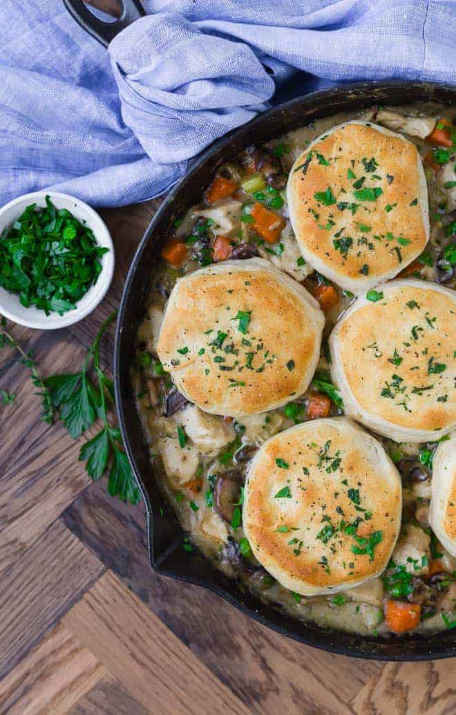 Image of skillet chicken pot pie, taken from above. Topped with biscuits.