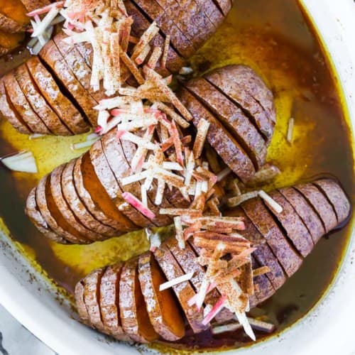 Image of sweet potatoes cut in a hasselback style and baked with cinnamon and butter.