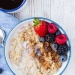 Image of instant pot steel cut oats topped with brown sugar, cinnamon, and fresh berries.
