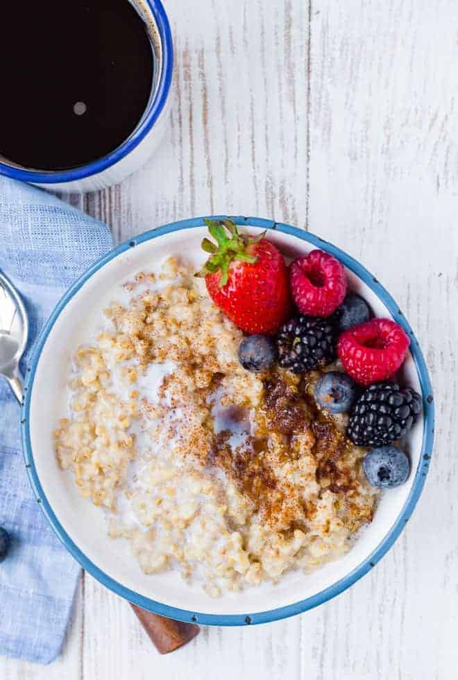 Image of instant pot steel cut oats topped with brown sugar, cinnamon, and fresh berries.