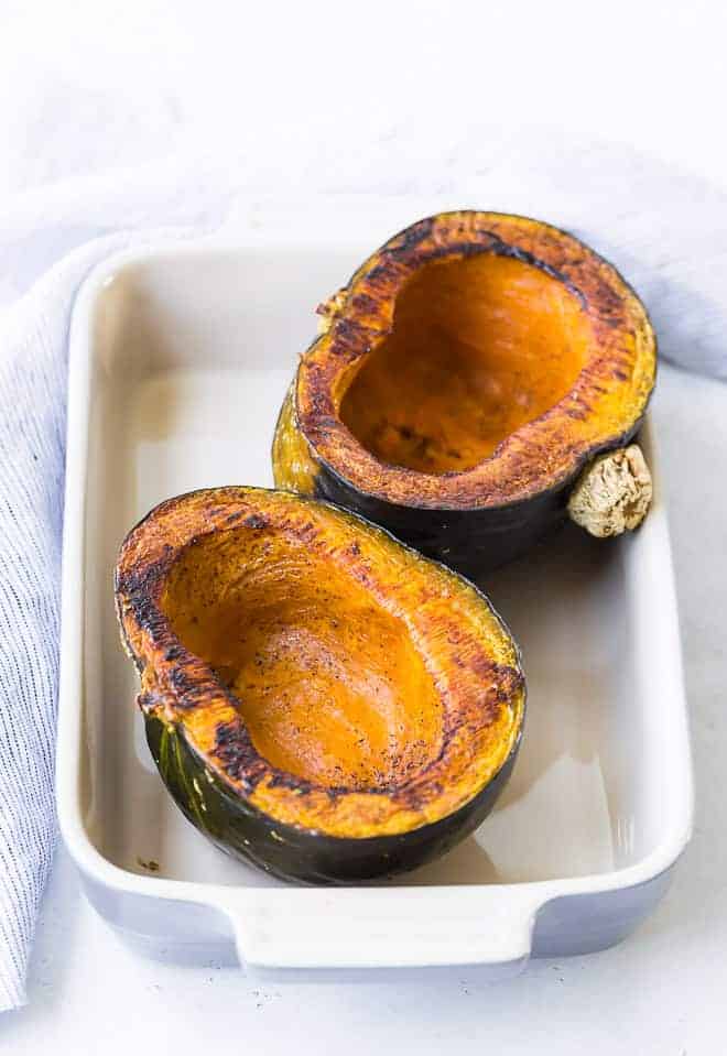 Image of two kabocha squash halves that have been roasted and hollowed out.