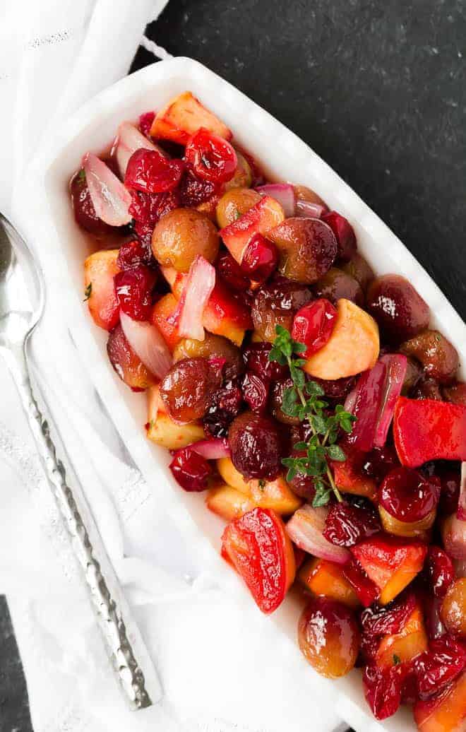 Add this beautiful jewel toned side to your holiday menu!  Cranberry sauce with roasted grapes, apples, and shallots provides a burst of flavor, both sweet and savory, that is unforgettable. 