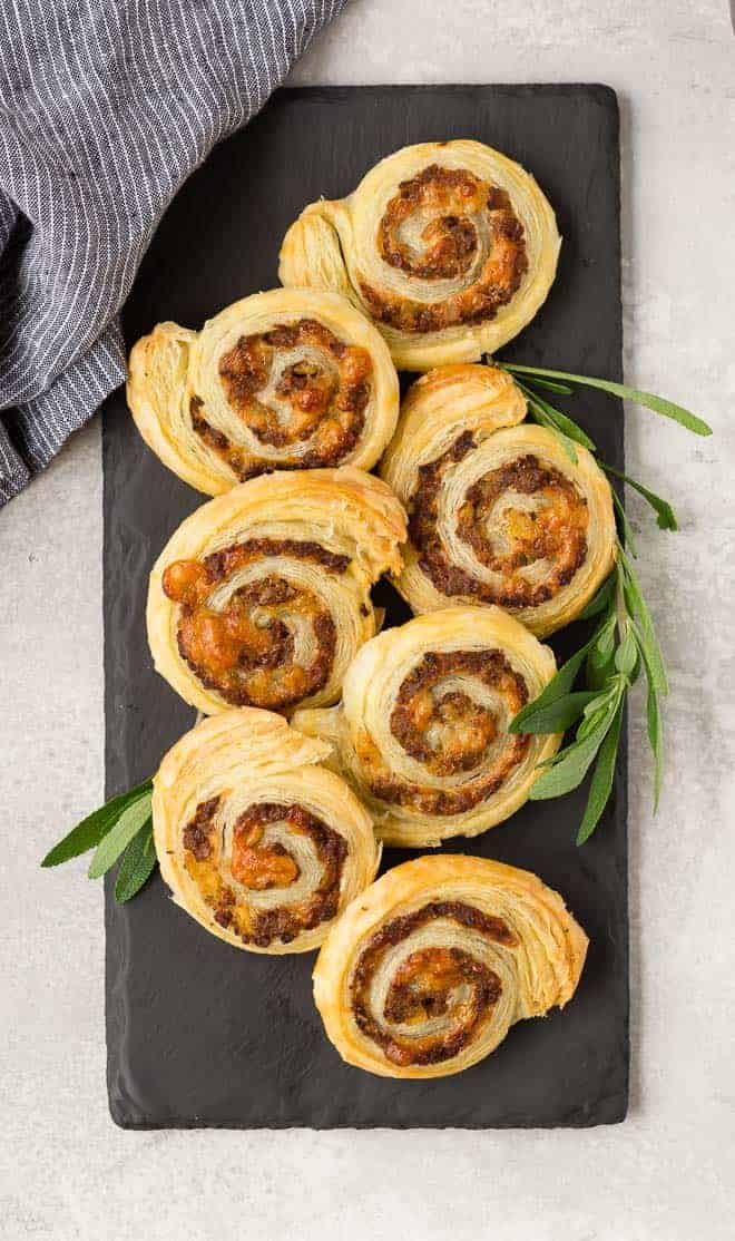 Sausage puff pastry wheels made with apple and gruyere, overhead view.