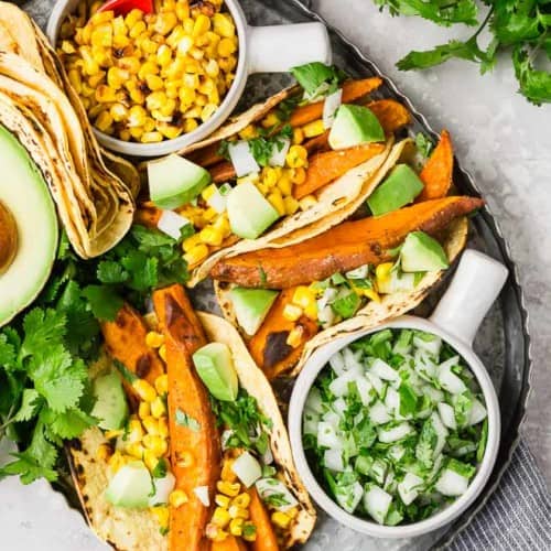 Beer marinated roasted sweet potatoes, charred corn, creamy avocado, crisp onions, and fresh cilantro, wrapped in a soft corn tortilla, make these vegetarian sweet potato tacos a taste sensation! 