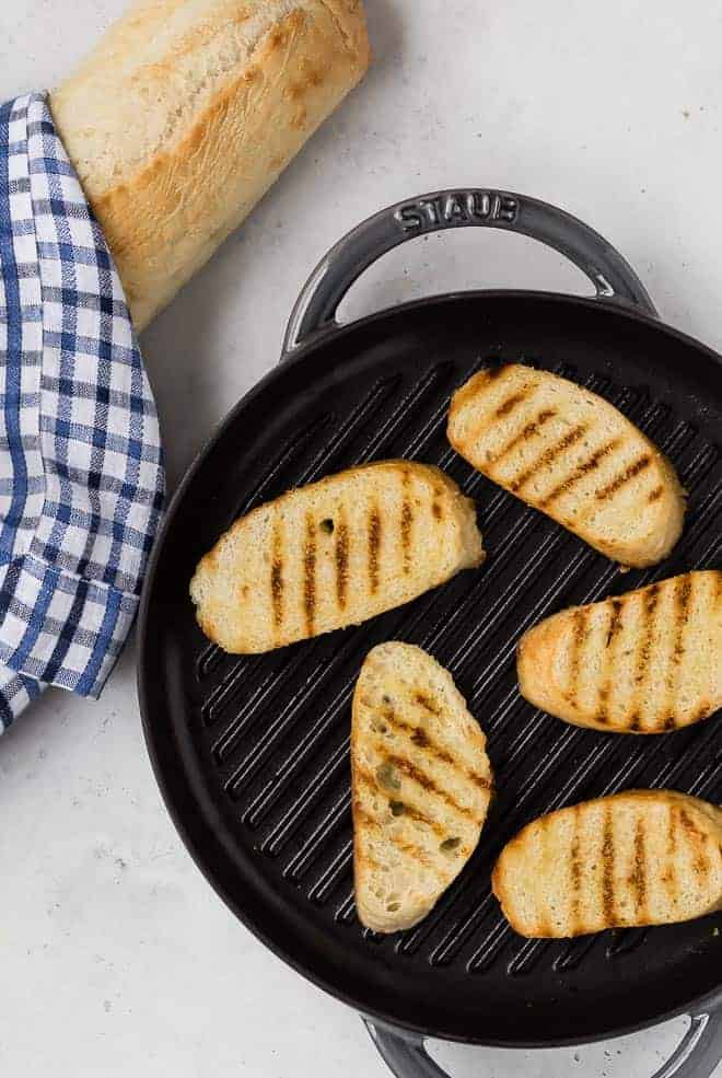 Image of bread toasted in a grill pan to make crostini.