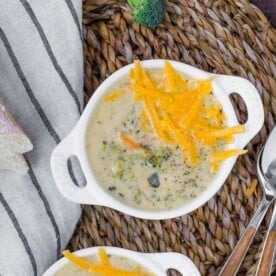 Image of pressure cooker broccoli cheddar soup in white bowls.
