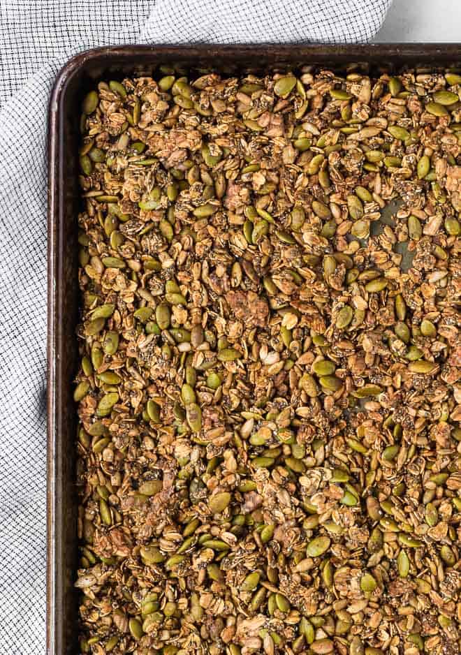 Image of savory granola on a large sheet pan.