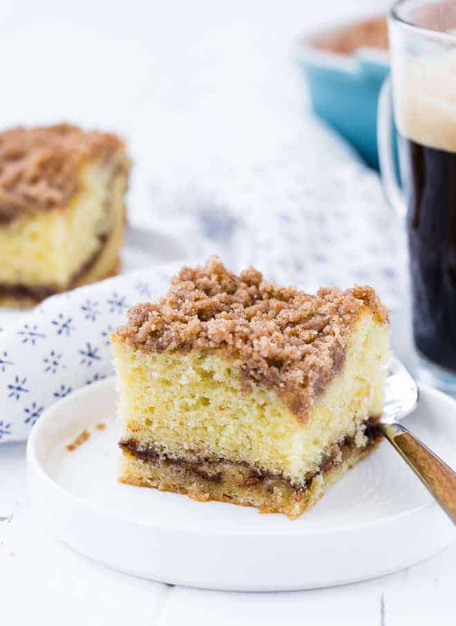 Image of a slice of coffee cake with streusel topping and cinnamon filling. 