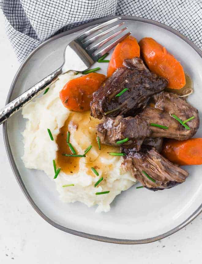 Image of tender pot roast, carrots, mashed potatoes, and gravy.