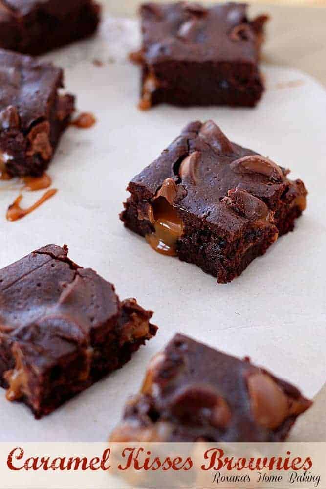 Overhead view of several caramel kissed brownies arranged on parchment paper. Text overlay reads "Caramel Kisses Brownies, Roxana's Home Baking."