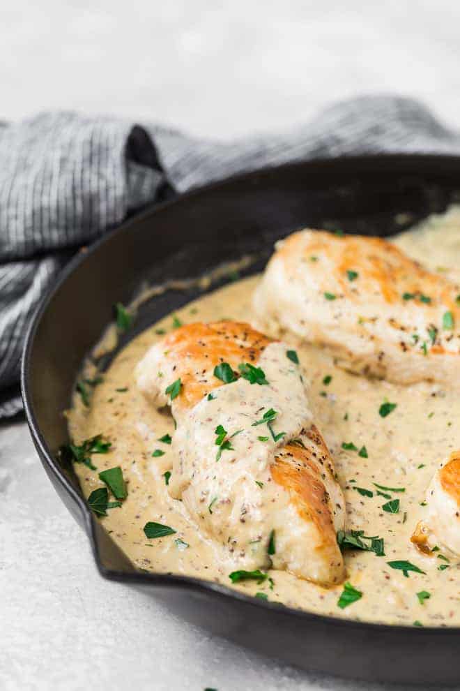 Image of creamy mustard chicken in a frying pan. 