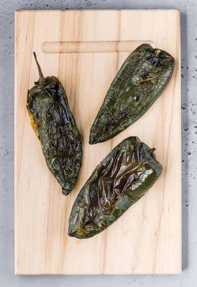 Image of roasted poblano peppers that haven't been peeled.