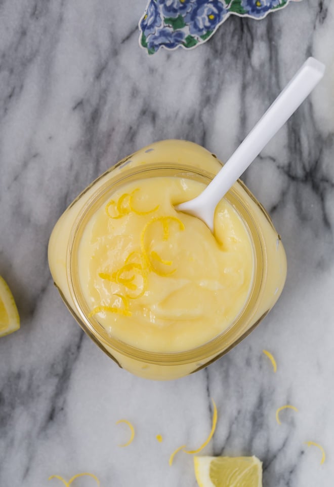 Overhead image of lemon cake filling in a small jar.