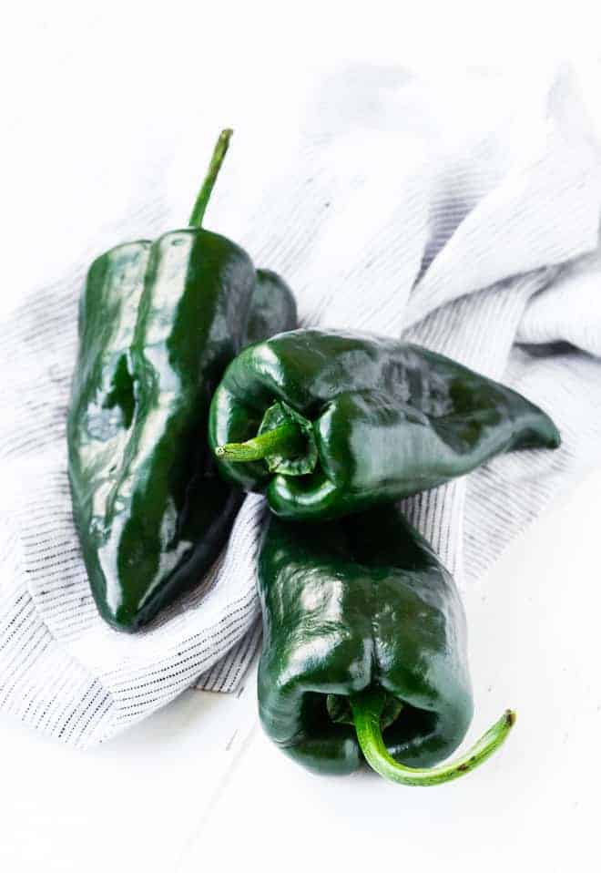 Image of fresh, raw, poblano peppers.