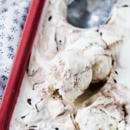 Fudge swirl ice cream in a red pan, with a scoop. Text overlay present with recipe name.