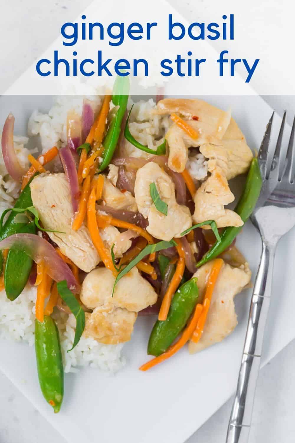 Overhead view of a white plate filled with white rice, chicken, sugar snap peas, carrots, and red onions in stir fry form. It is garnished with fresh basil ribbons.