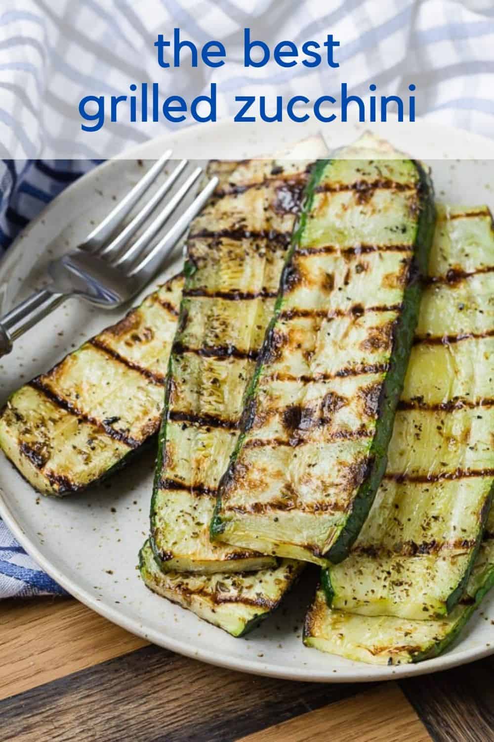 Overhead view of stacked up slices of grilled zucchini.