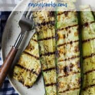 Overhead view of stacked up slices of grilled zucchini.