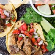 Carnitas in a corn tortilla with pico de gallo.