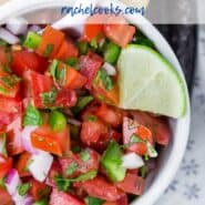 Overhead view of a white bowl of tomatoes, jalapenos, and onions with a text overlay that reads "the best pico de gallo"