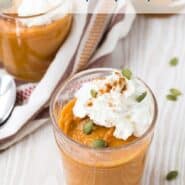 Pumpkin pudding garnished with whipped cream and pumpkin seeds.